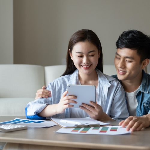 A couple looking at their finances together on the couch